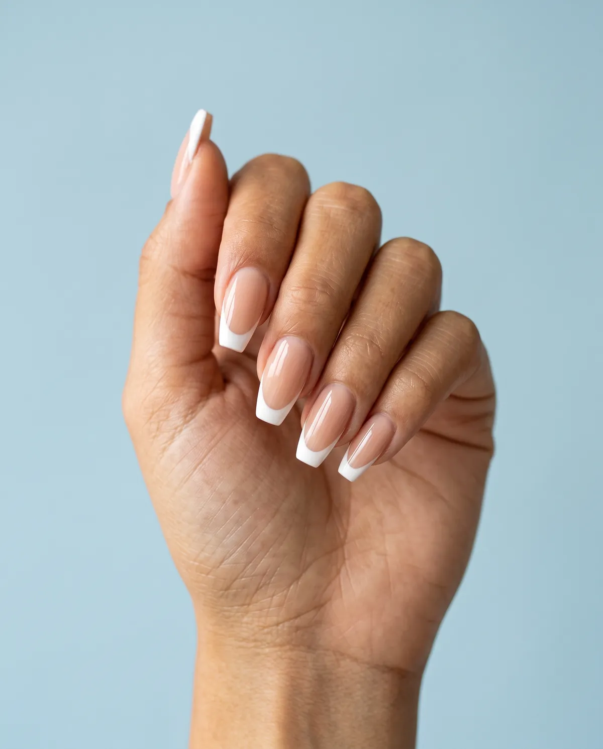 Clean White Tip — coffin nails with classic white french tip over a sheer nude base on a medium coffin shape