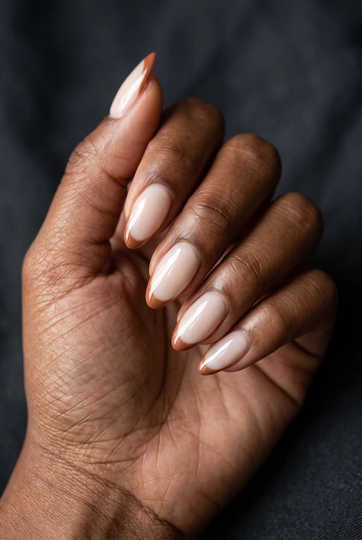 Cinnamon Glaze French — almond fall nails with sheer milky base with a thin cinnamon-brown french tip, glossy finish, almond shape