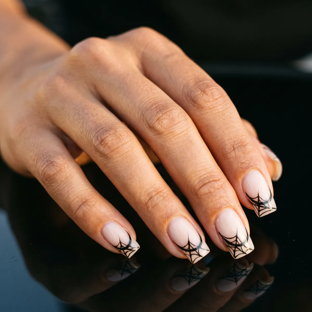 Negative Web French — square halloween nails with sheer milky base with a thin negative-space spiderweb drawn in black gel liner over a…