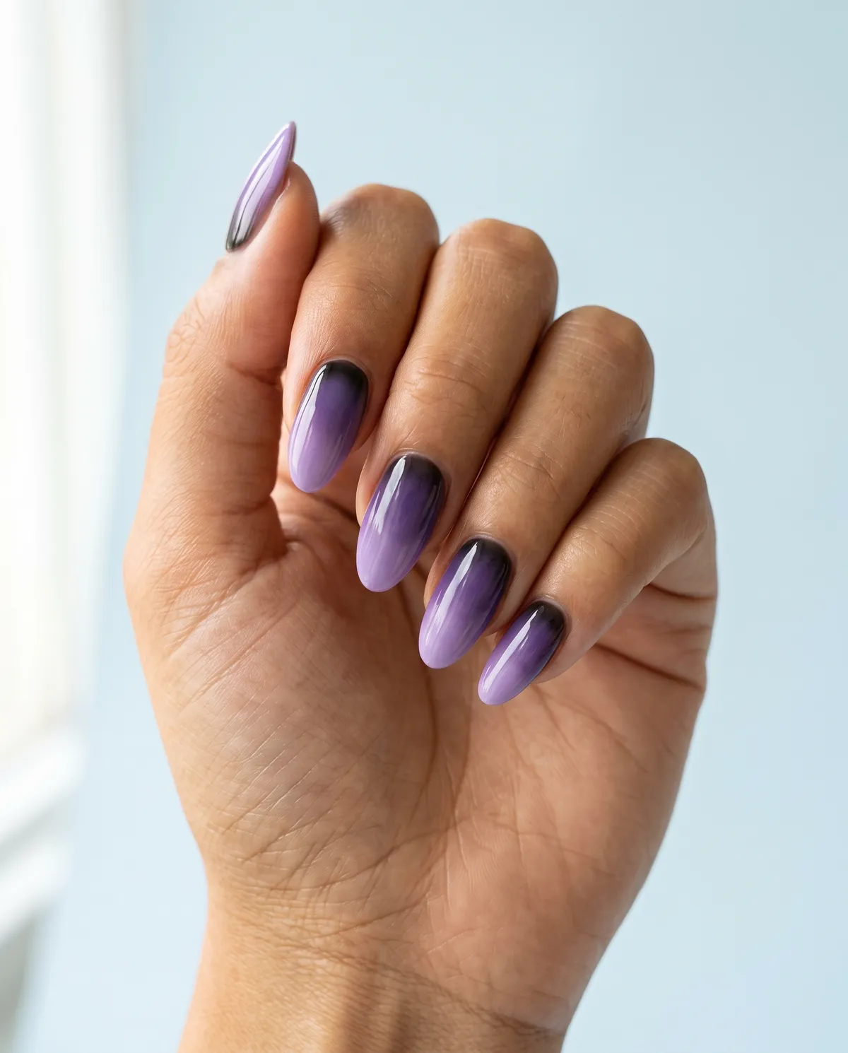 Witch Violet Aura — almond halloween nails with violet aura gradient airbrushed from base to mid-nail over a sheer black cuticle shadow…