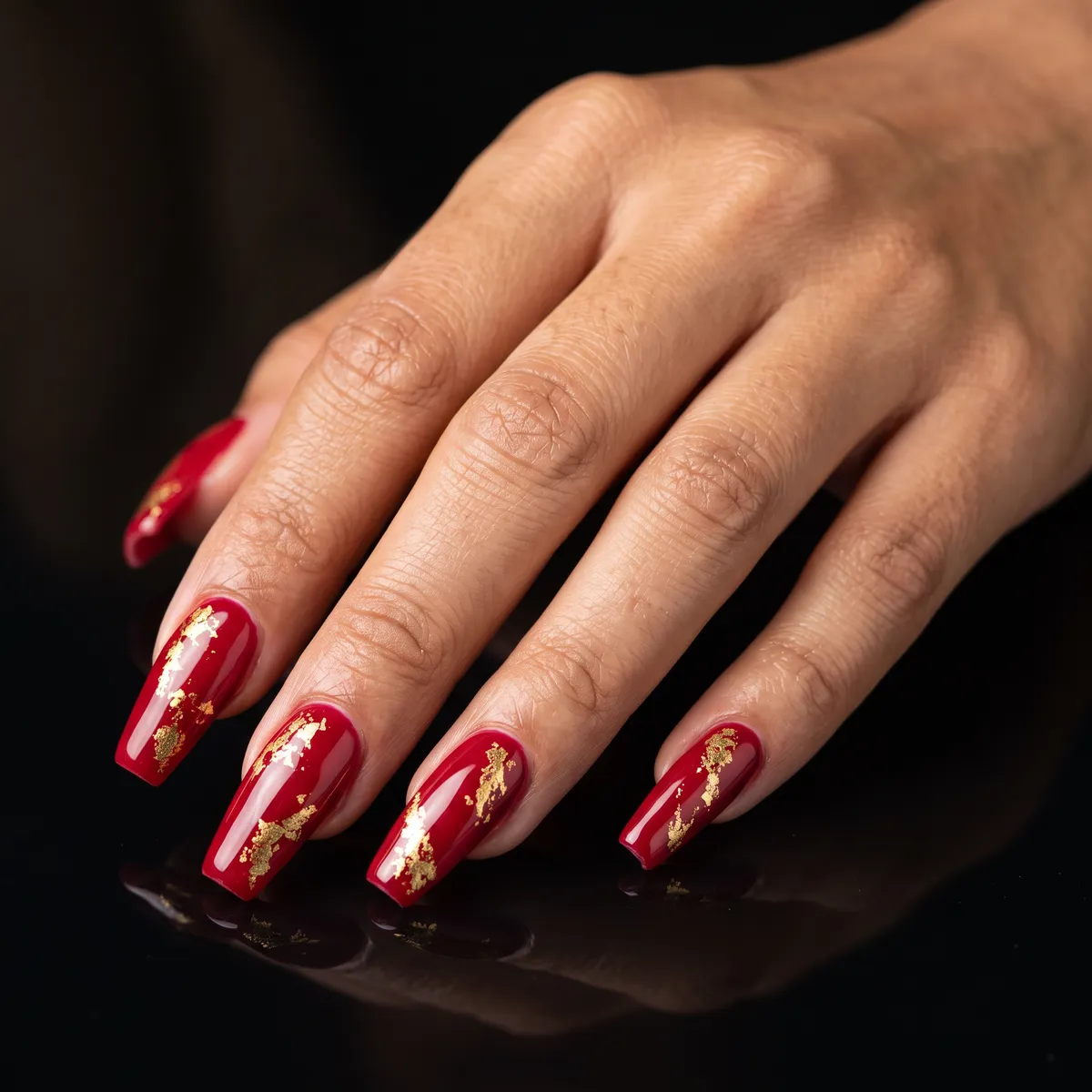 Ruby Foil — coffin red nails with ruby red gel base with pressed gold foil accents on long coffin nails