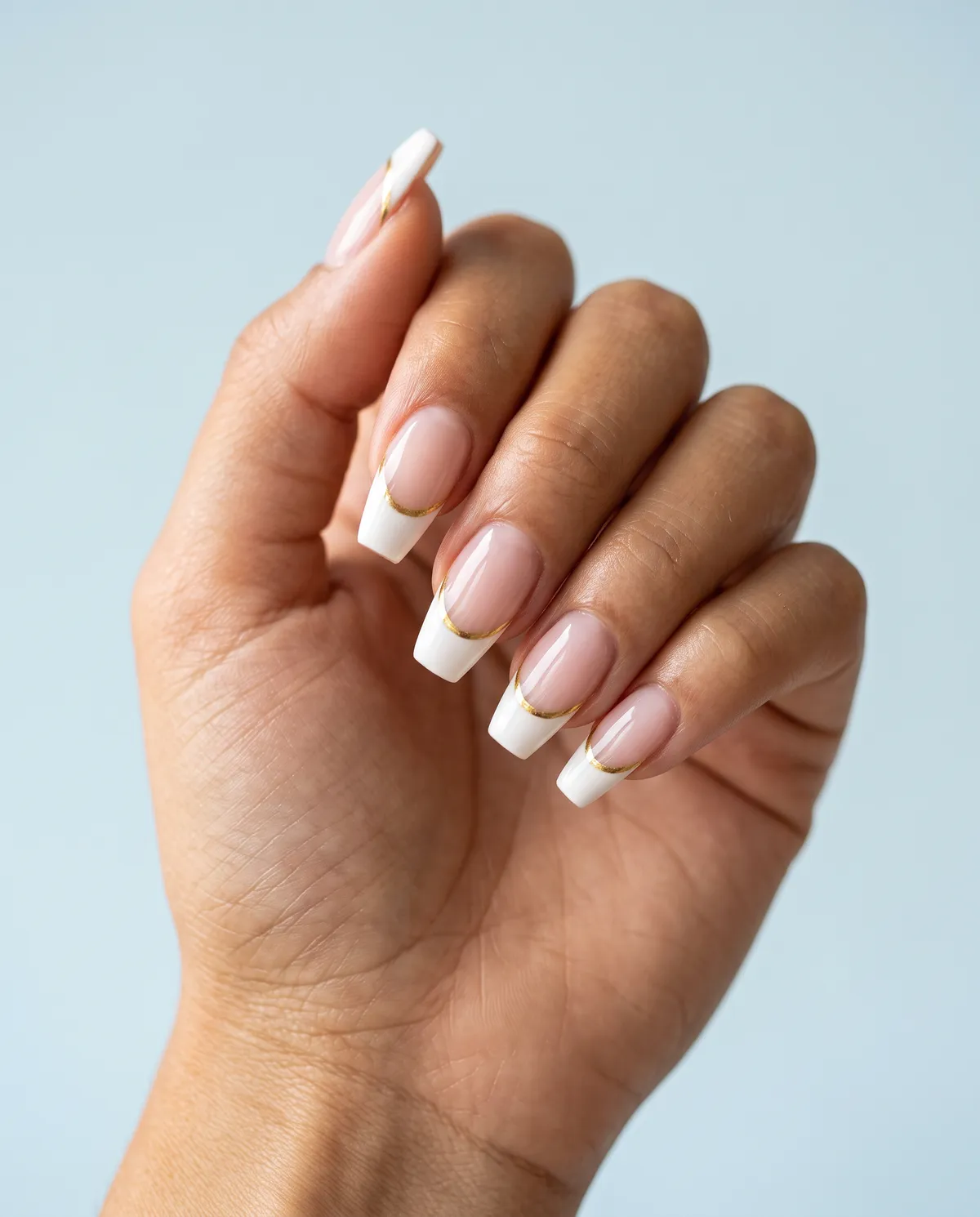 Gold-Line French — coffin french nails with white french tips with a thin gold chrome line traced along the smile line, short coffin